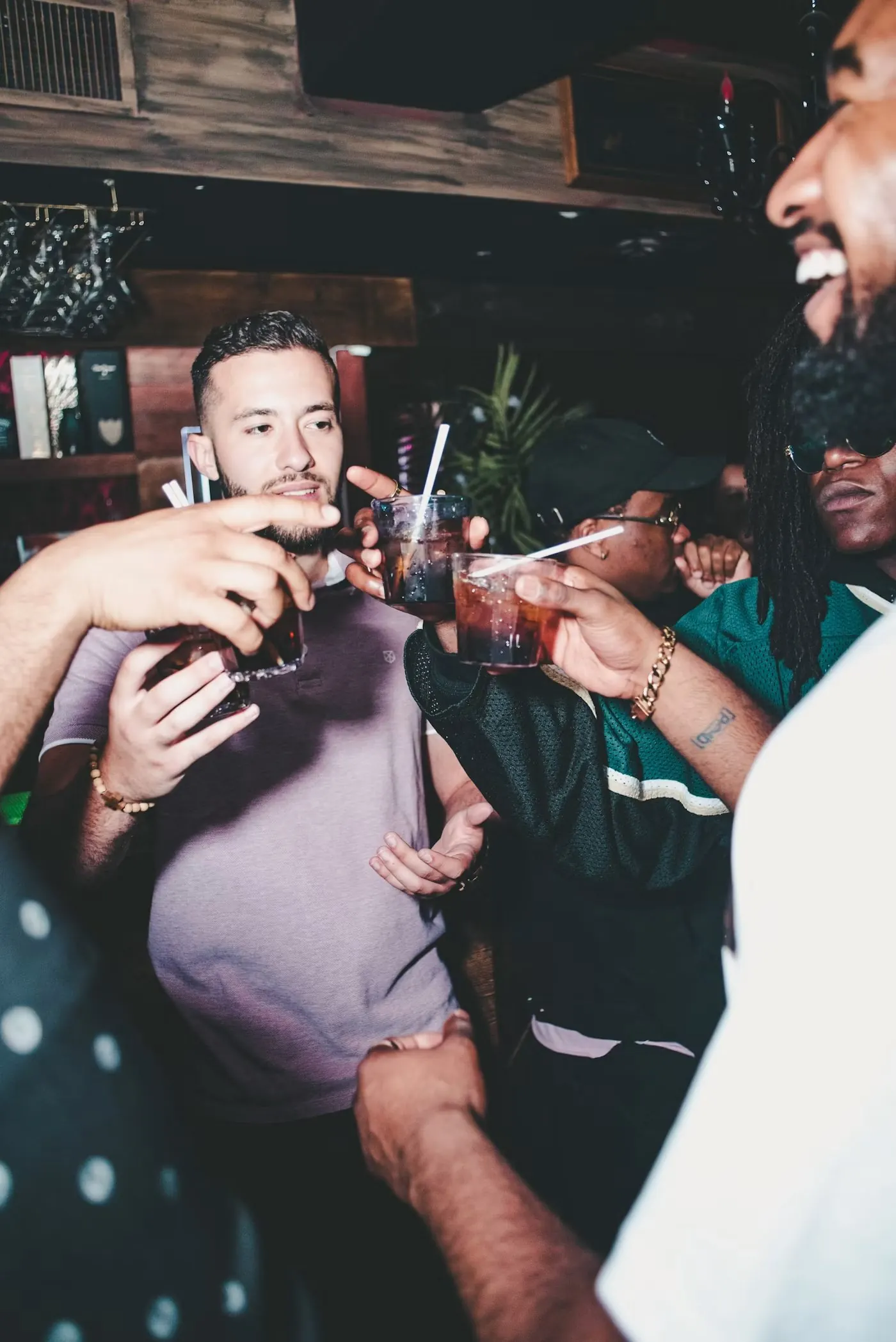 Group of friends toasting at night