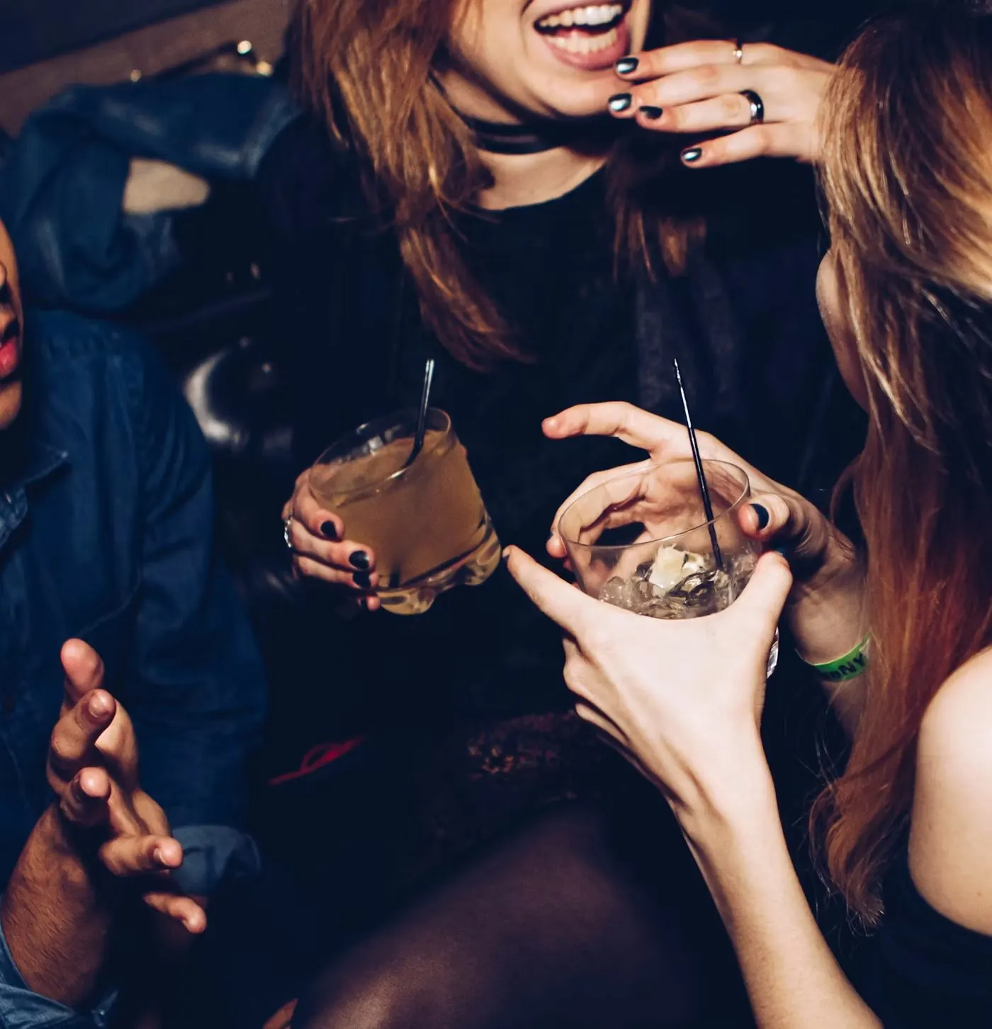 Friends laughing with drinks in hand